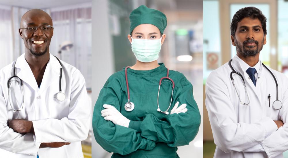 three doctors in scrubs and white coats