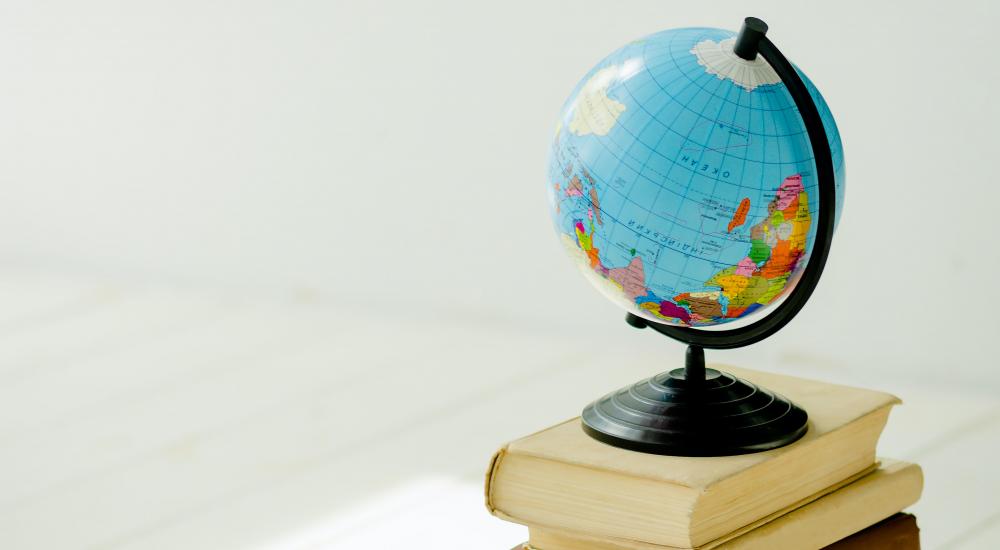 Image of a small globe on top of a stack of books