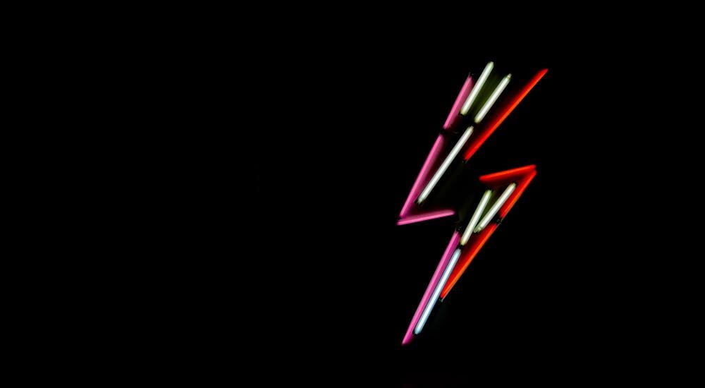 Neon lightning bolt on black background