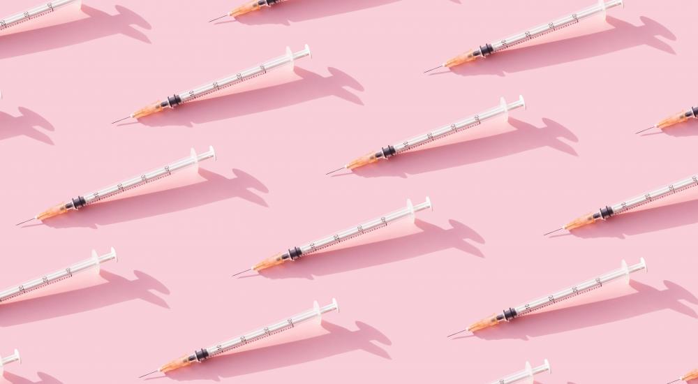 syringes on a pink background