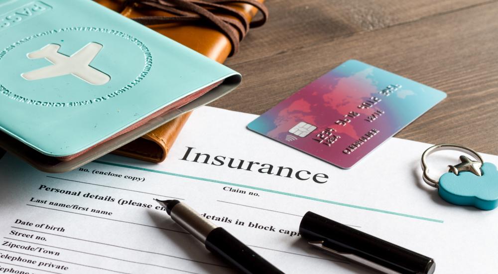 travel documents and insurance forms on a desk