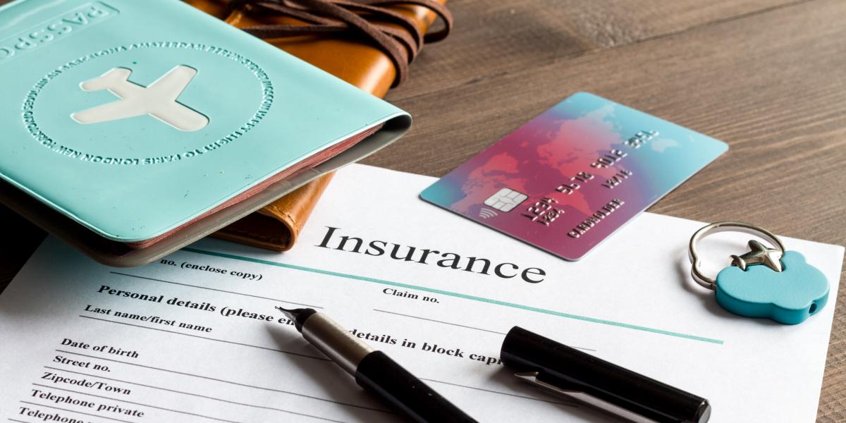 travel documents and insurance forms on a desk