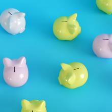 Different colored piggy banks on a blue background