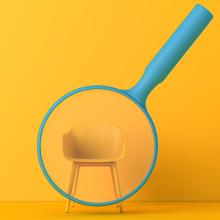 Blue magnifying glass over a yellow chair