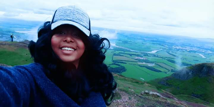 A student with landscape behind her