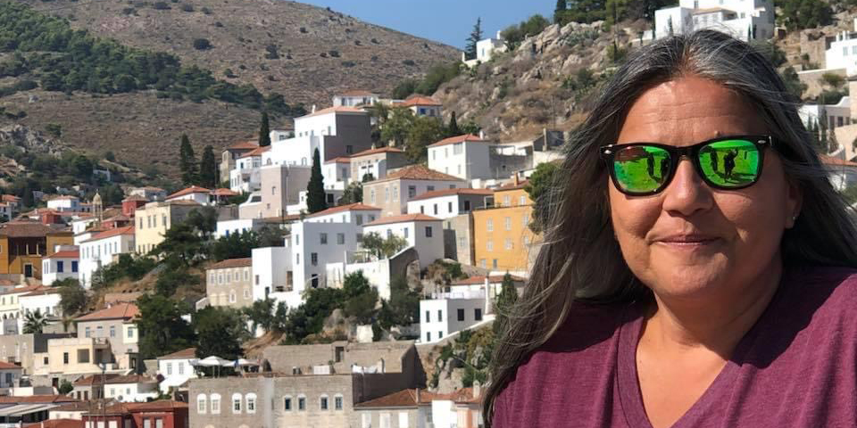 A student with Greek village in the background