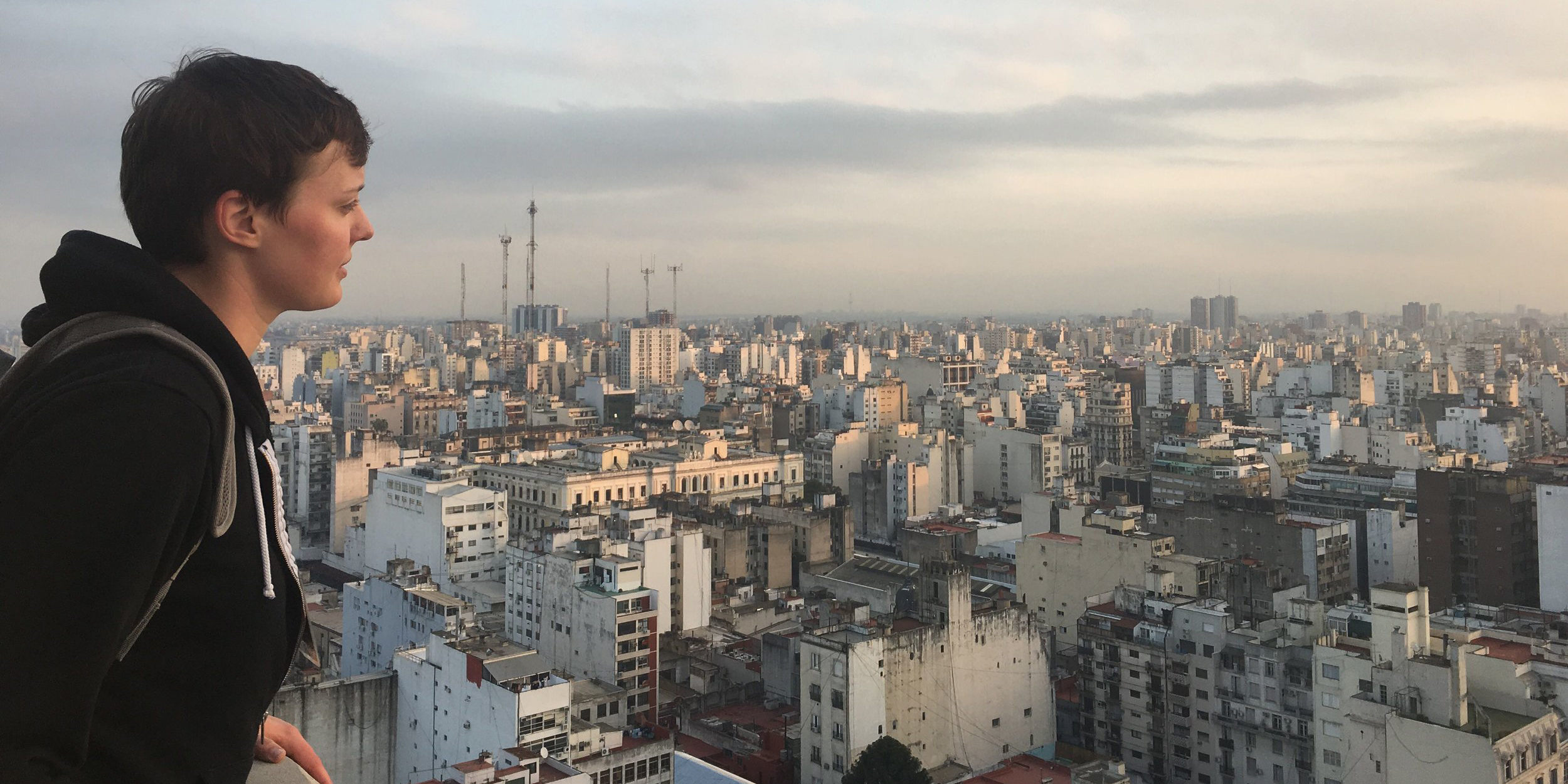 A student looks over a cityscape