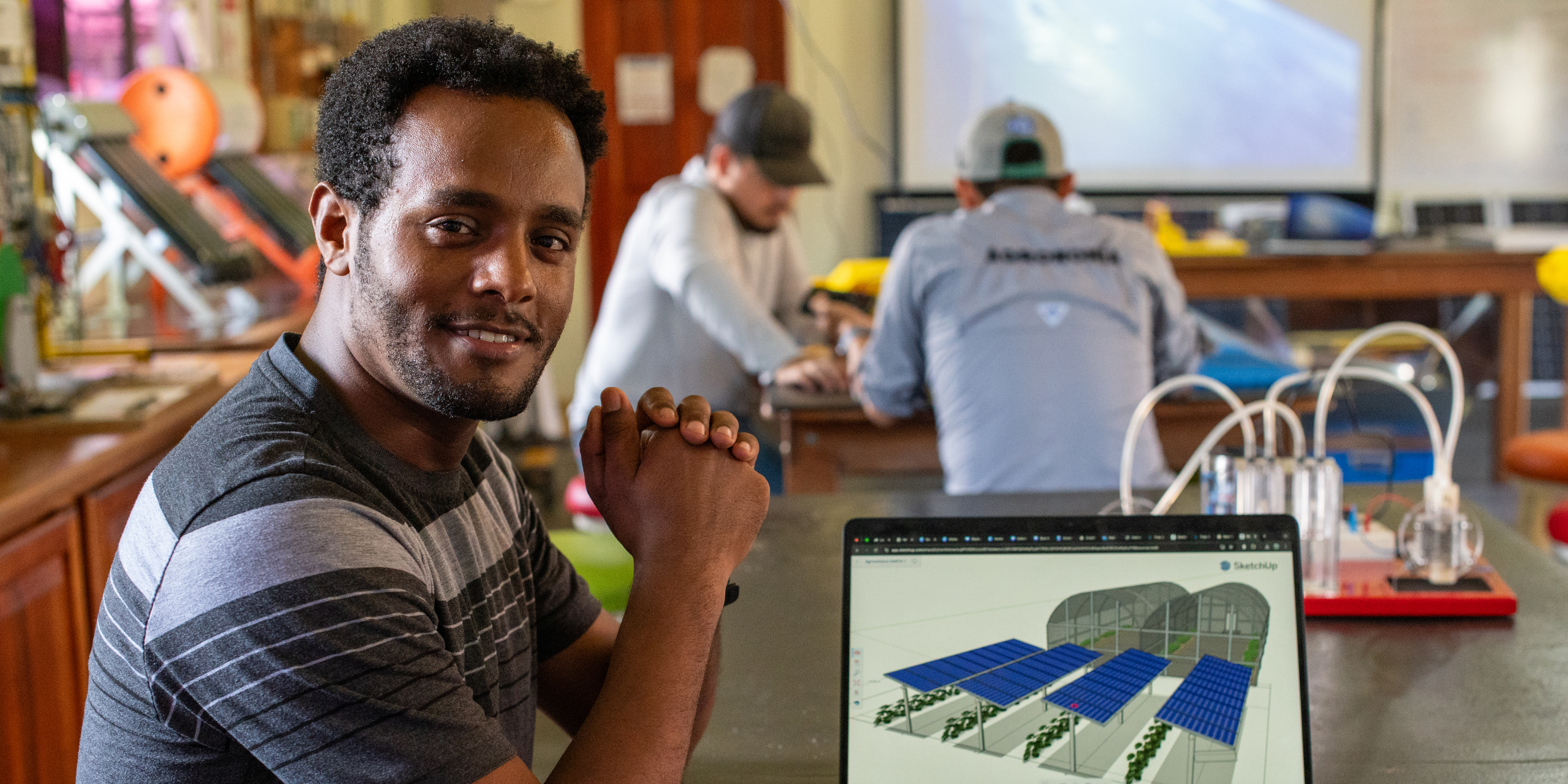 A student in a classroom with a computer.