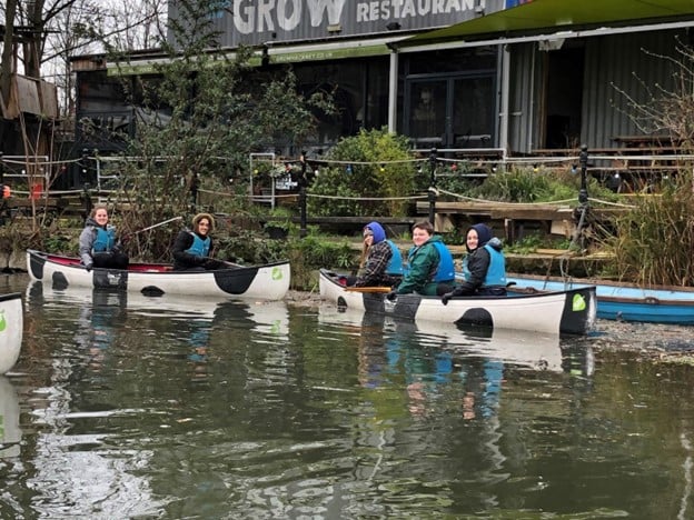 A group of CC students in canoes cleaning waterways in London