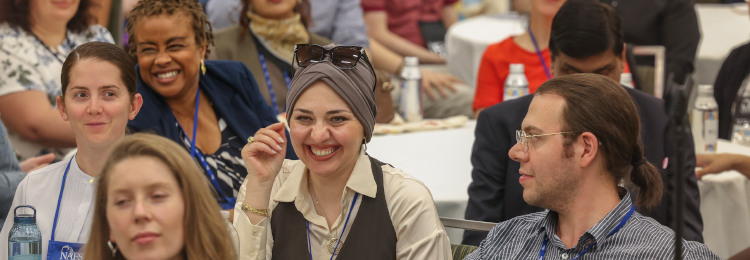 A diverse group of smiling people at the conference
