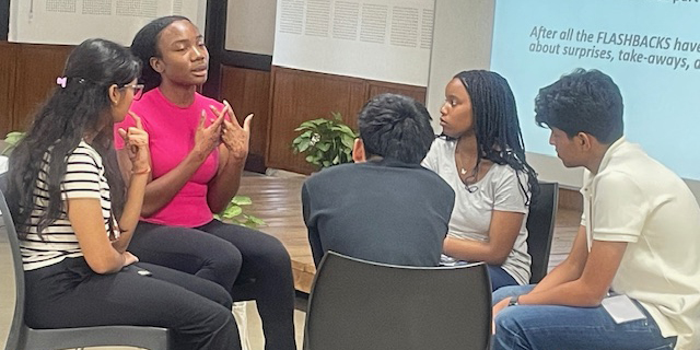 a group of students sitting in a circle talking