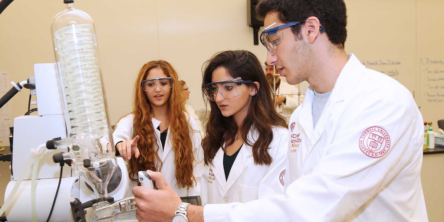 Three students working in a lab.
