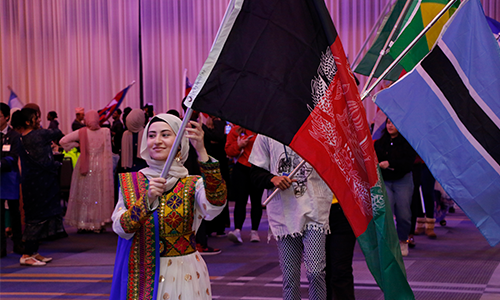UK student holds the Afghan flag during International Day