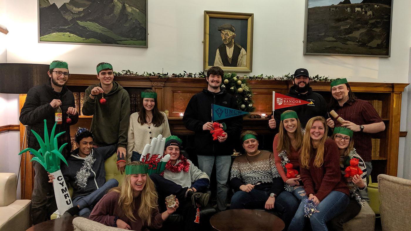 Students participating in the FYSA in the United Kingdom program pose with swag from both institutions