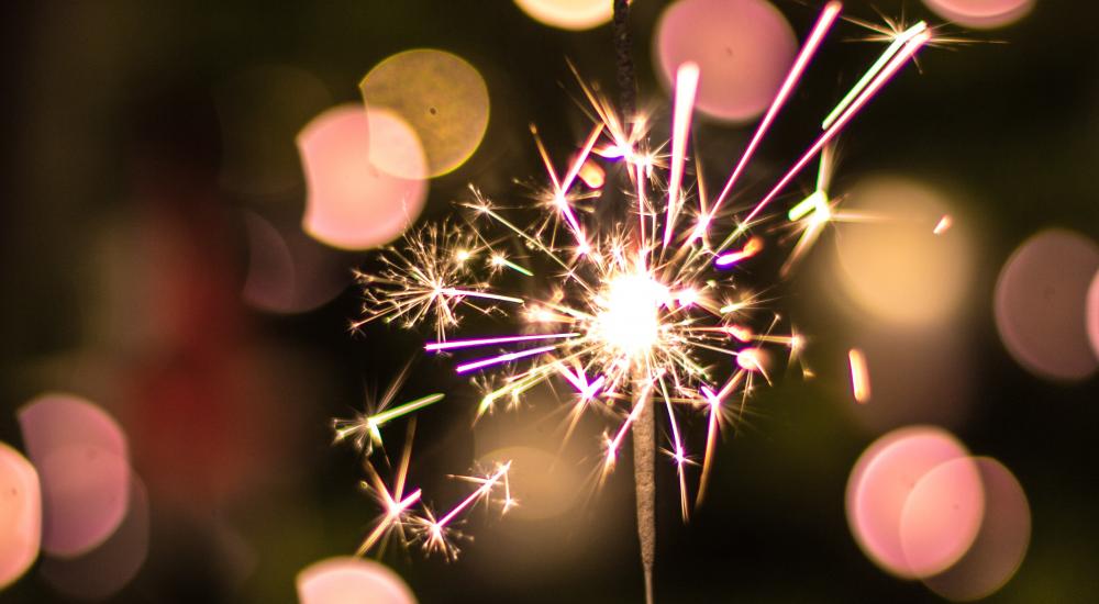 Pink sparkler on black background