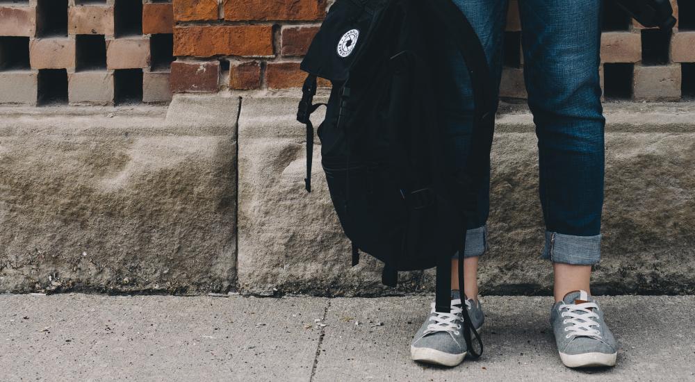 Student holding a backpack