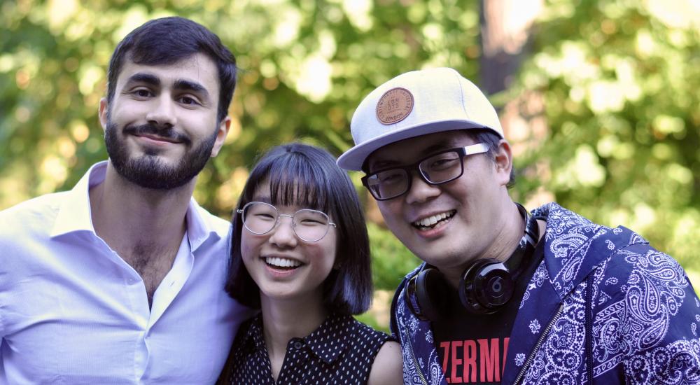 Three students smiling