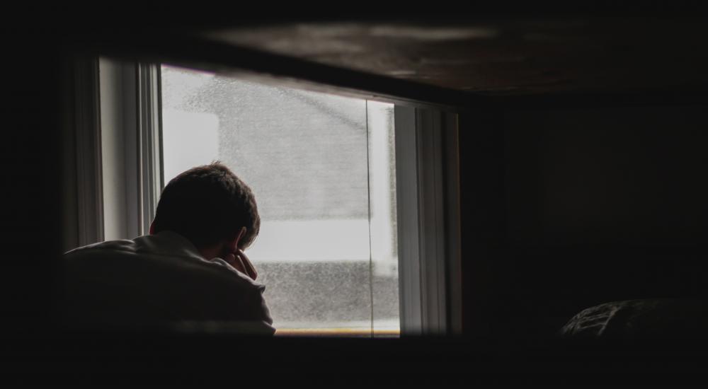 Man looking out a window