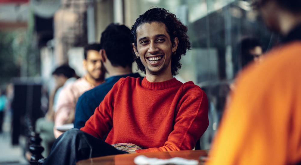 Student sitting at a cafe table