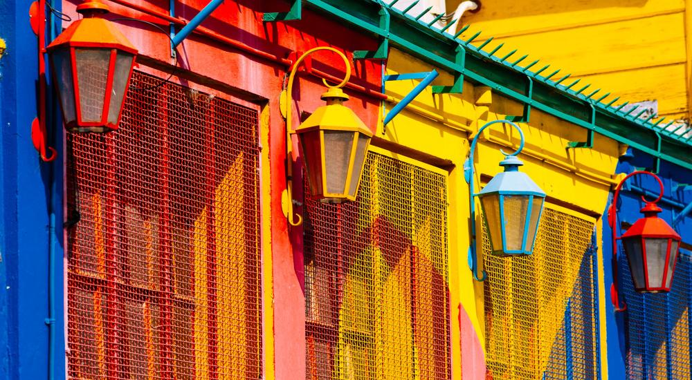 photo of brightly painted building with lamps
