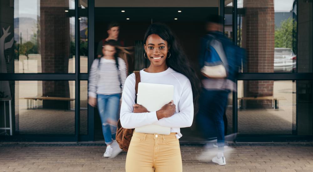 A student standing in front of a doorway