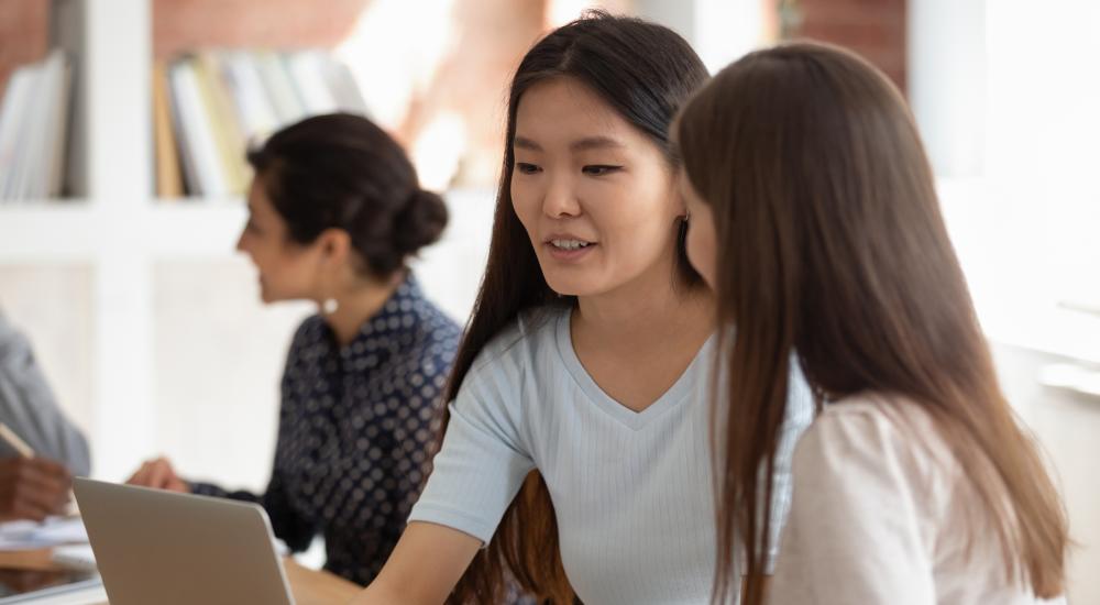 Two students sitting at a laptop together