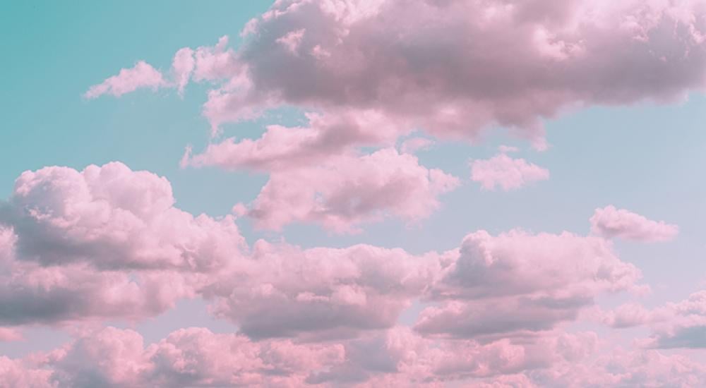 Pink clouds against a blue sky