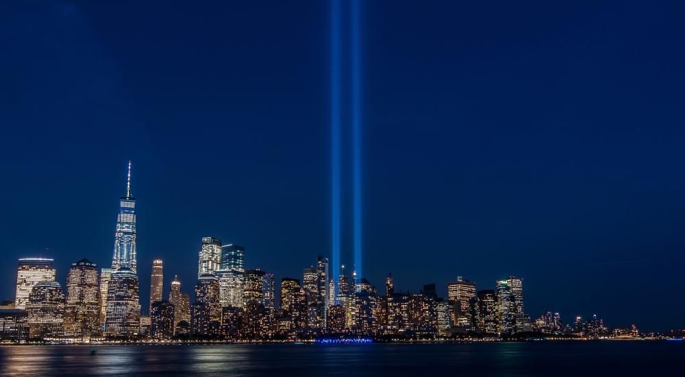 New York City skyline with spotlights where the Twin Towers were.