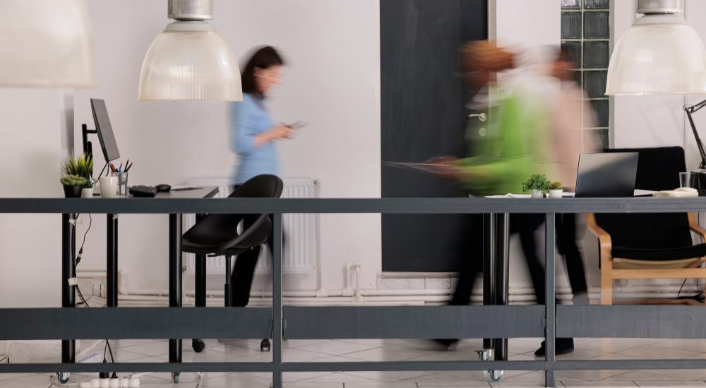 Photo of people moving around in an office