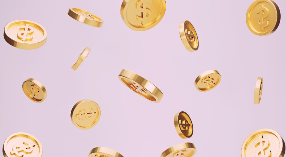 Coins floating against a pink background