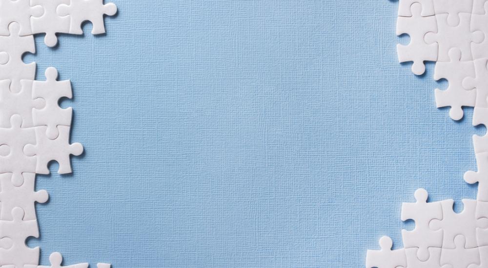 uncompleted blank puzzle on blue background