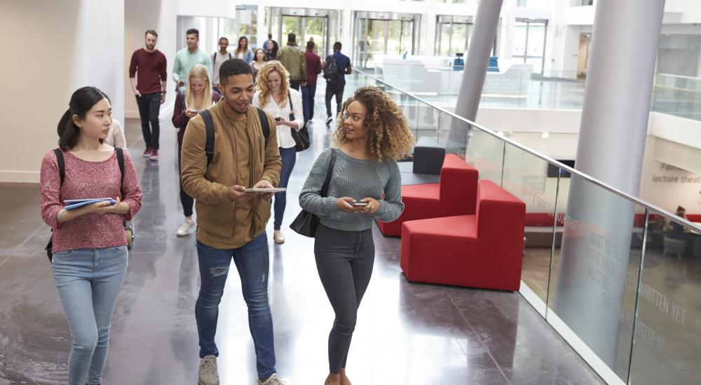 Student walking together in a building on campus