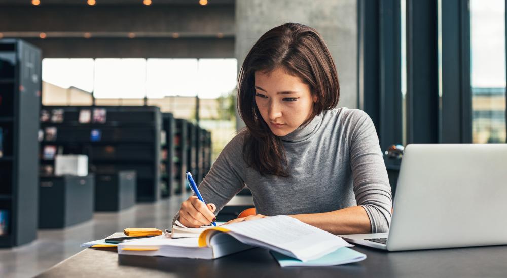 Young woman studying in library