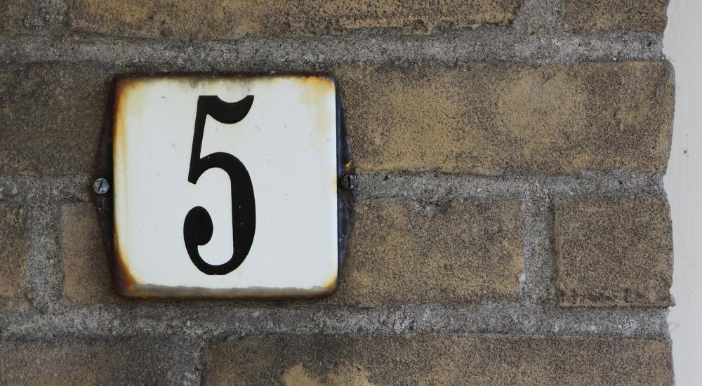 The number five on an address placard
