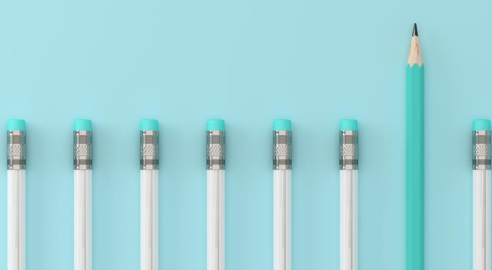 line of pencils on a blue background