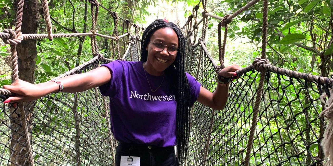 A student explores a rope bridge in Ghana.