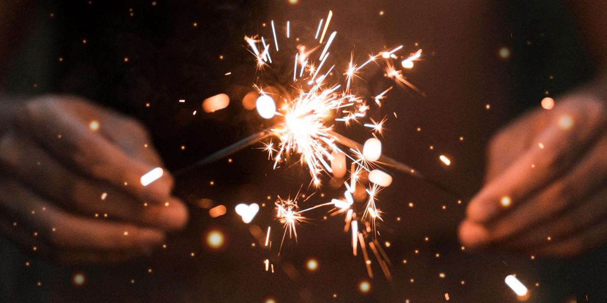 Two hands holding sparklers