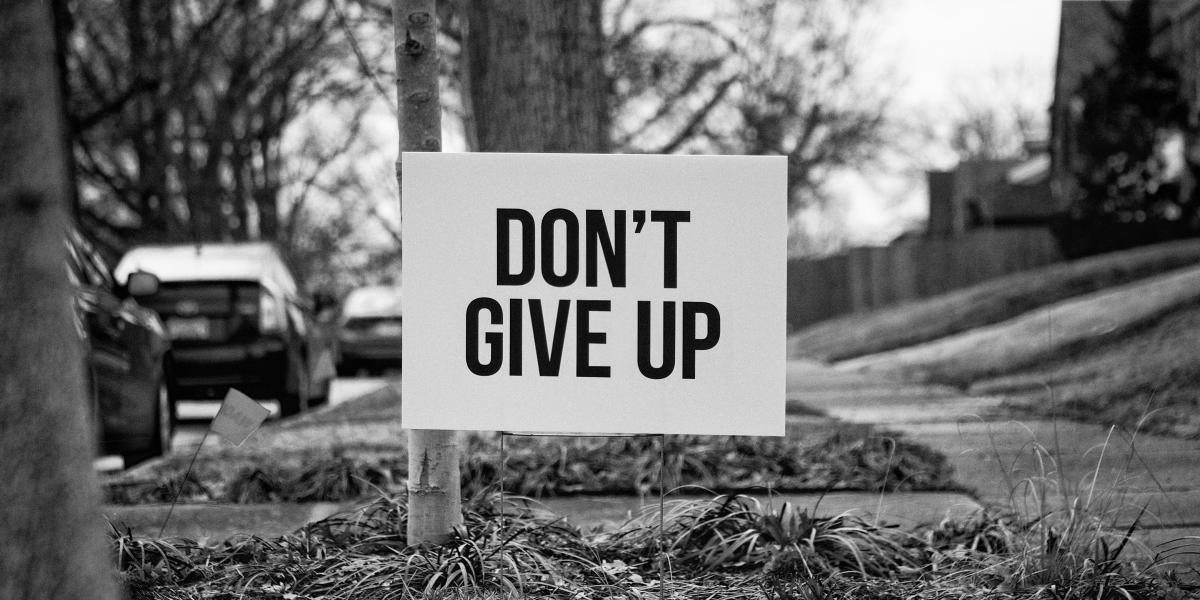 Yard sign that says, Don't Give Up