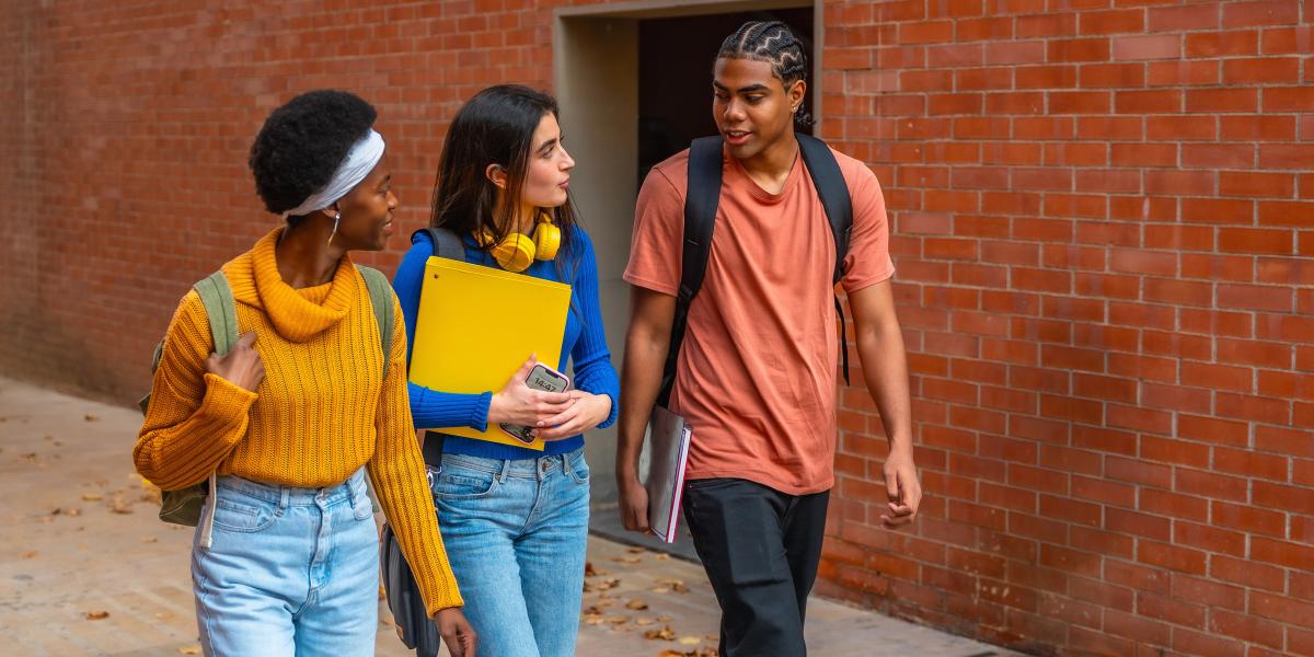 group of young people walking and talking
