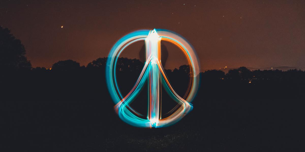 long exposure photograph of peace sign in light