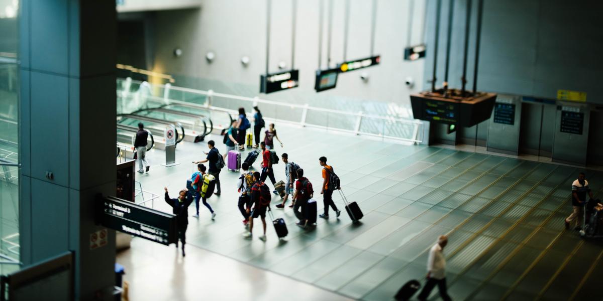 Photo of people walking through an airport