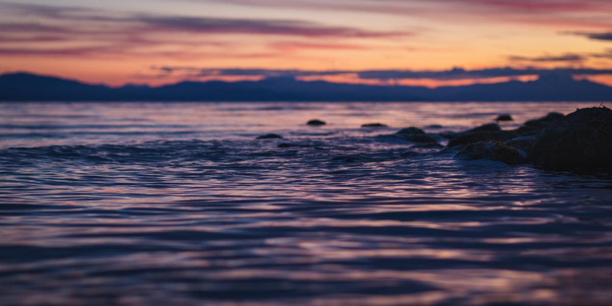 Sunset over water and rocks