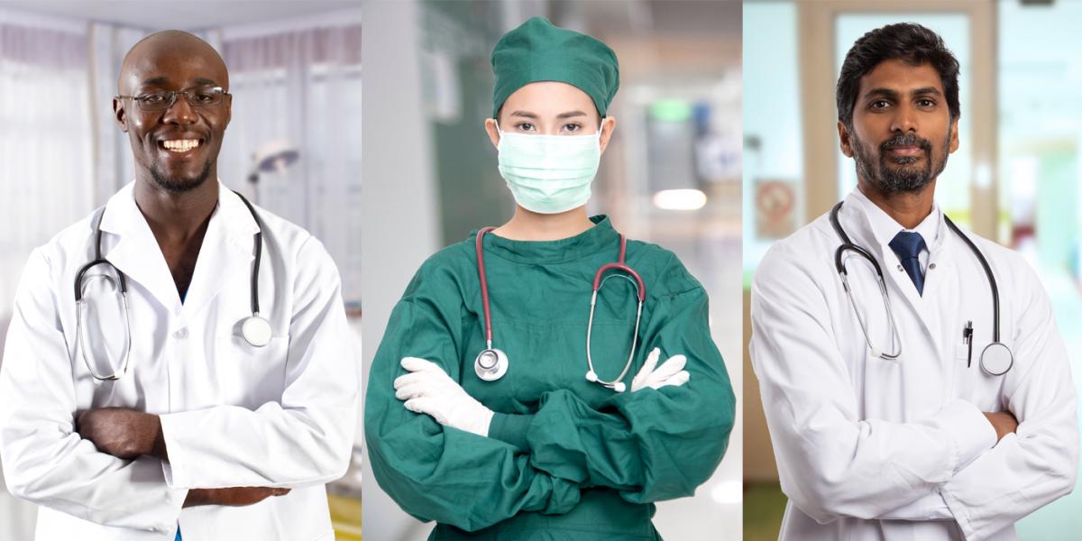 three doctors in scrubs and white coats