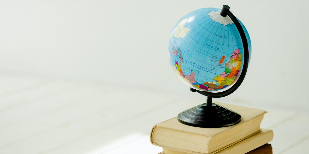 Image of a small globe on top of a stack of books
