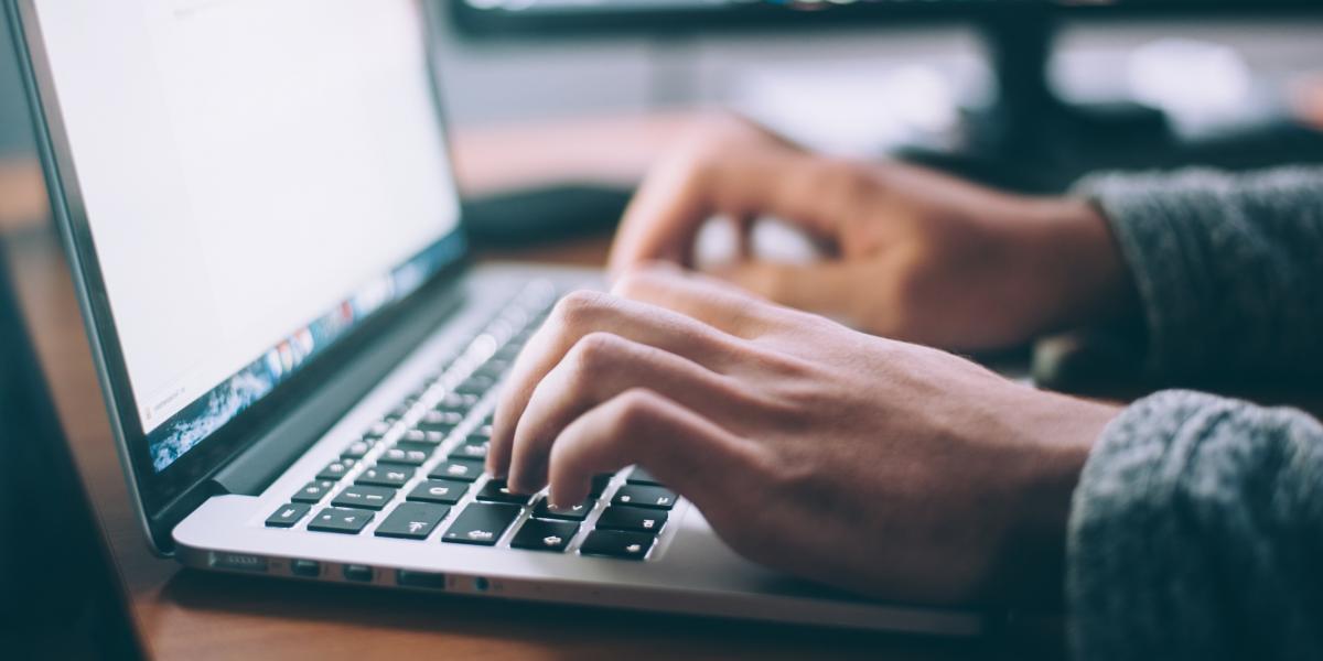 hands typing on a laptop