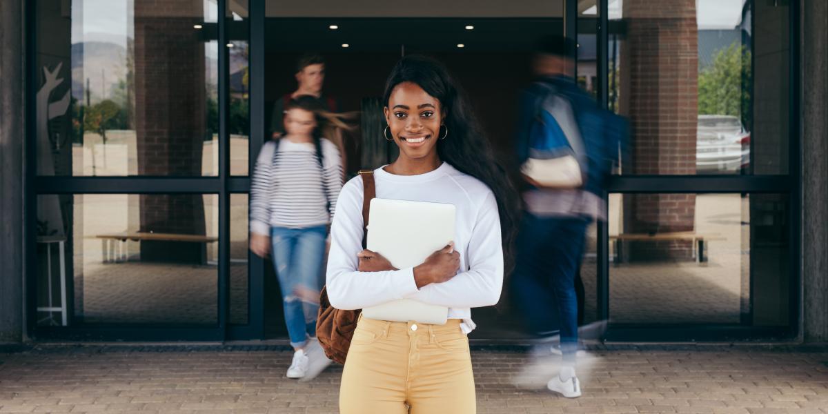 A student standing in front of a doorway