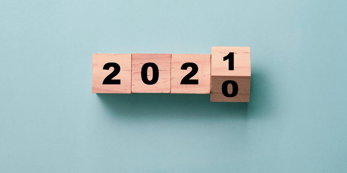 wooden blocks on a blue background turning from 2020 to 2021