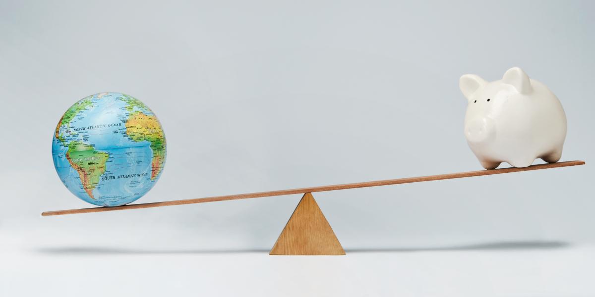 globe and piggy bank balancing