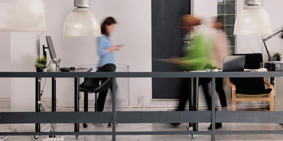 Photo of people moving around in an office