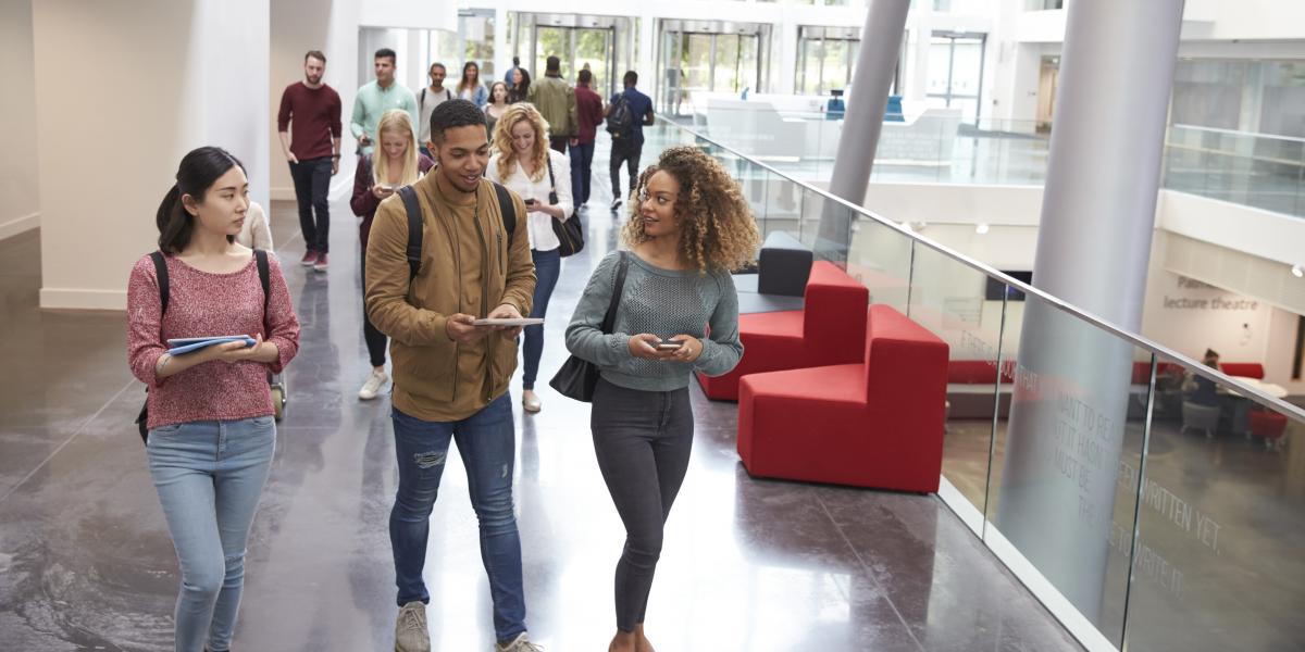 Student walking together in a building on campus